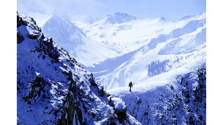 Male hiker mountaineering in winter