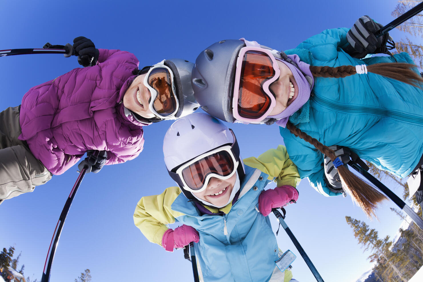 Grinning family skiing together