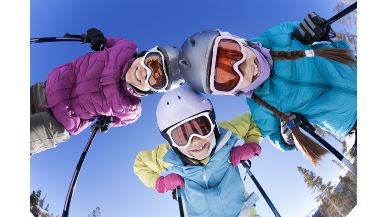 Grinning family skiing together