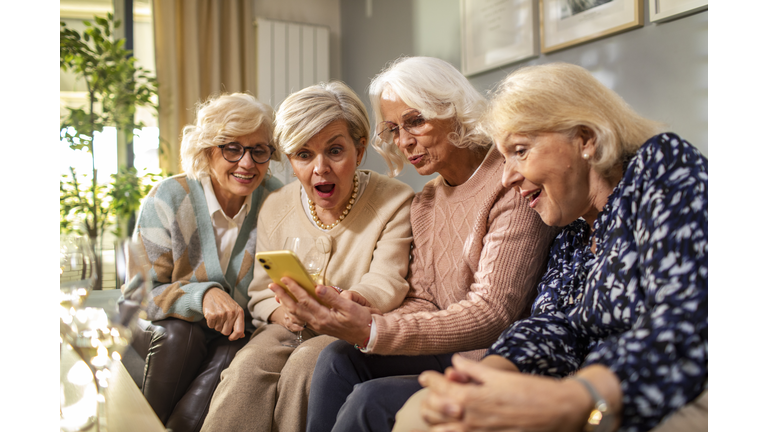Senior women using a phone at home