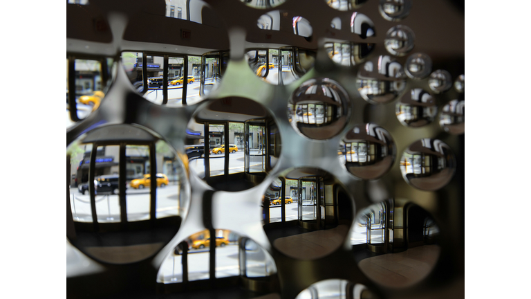 A New York street scene is reflected thr