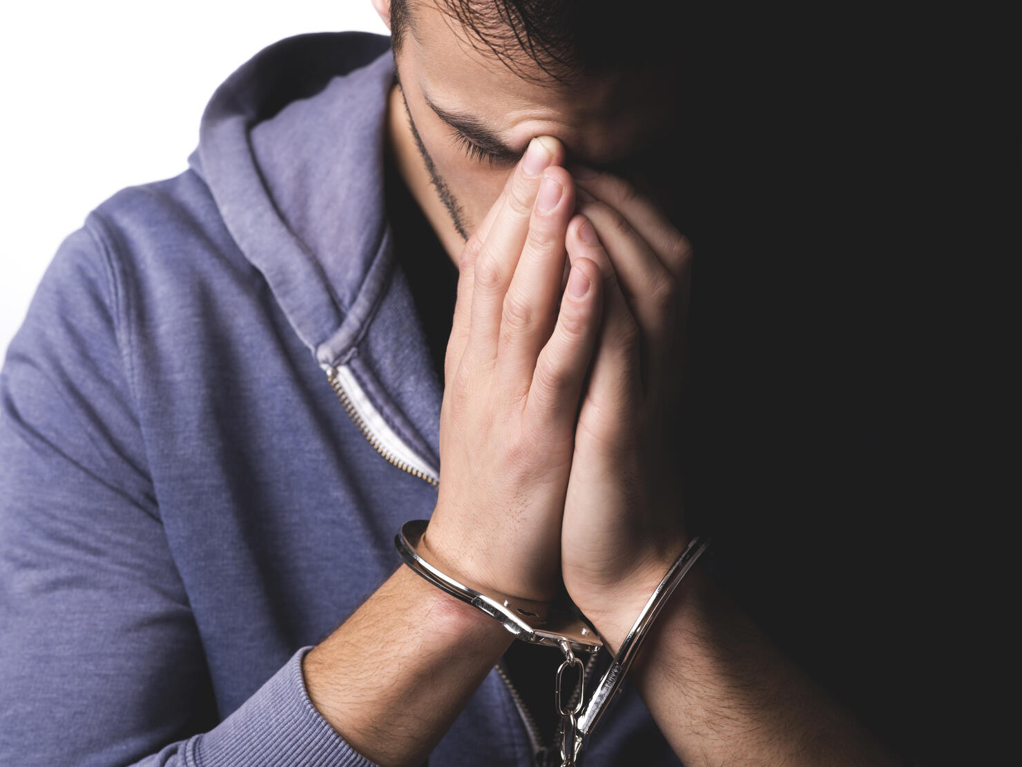 Young man arrested with handcuffs on his hands