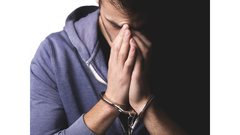 Young man arrested with handcuffs on his hands