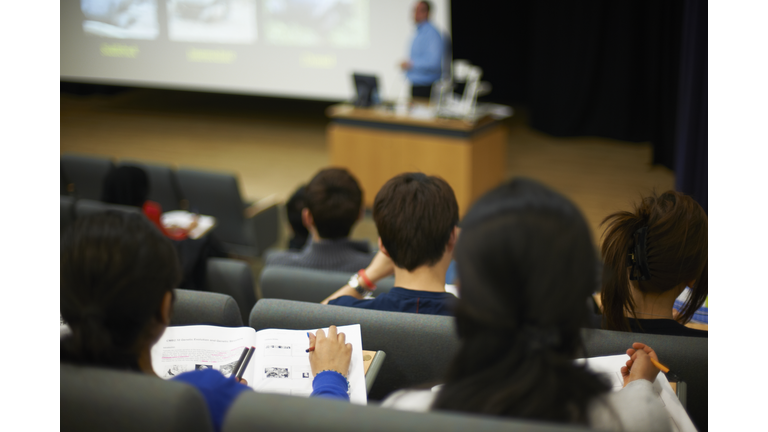 Students reading book in class