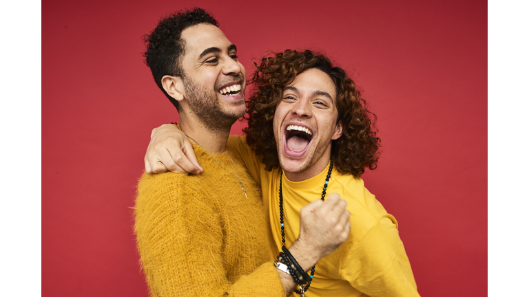 Colourful studio portrait of a gay male couple