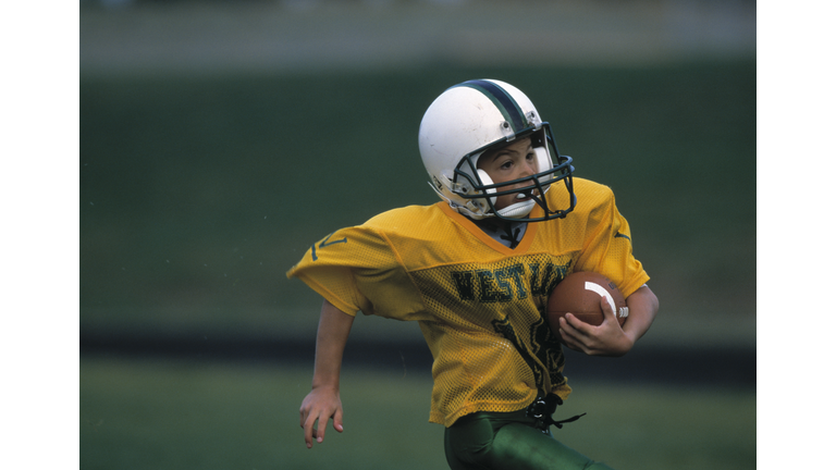 Boy Runs With Football