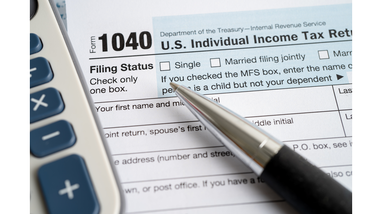 Tax Return form 1040 with USA America flag and dollar banknote, U.S. Individual Income.
