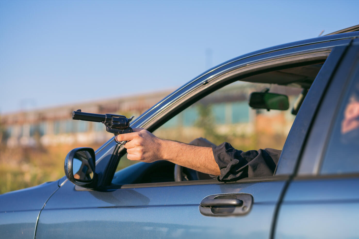 criminal discharging a gun through a window of a moving car
