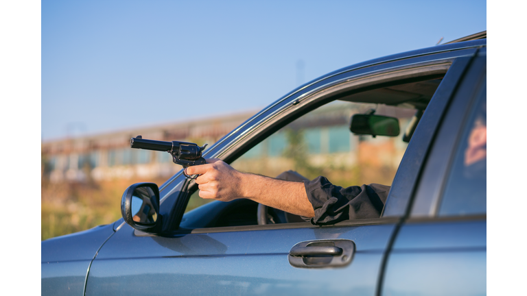 criminal discharging a gun through a window of a moving car