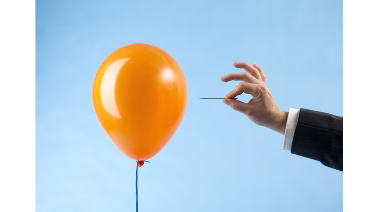 Balloon attacked by hand with needle