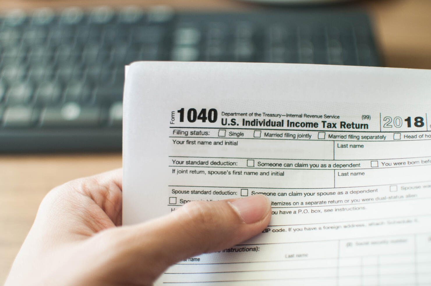 A young man holding a tax form