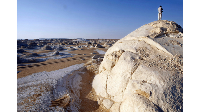 A man stands on a chalk Inselberg and lo