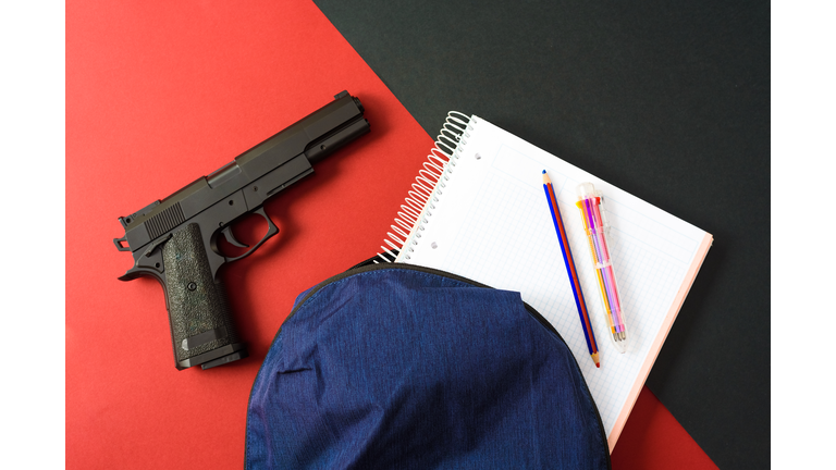 A firearm on the backpack of a young man at school, a loaded gun in a school.