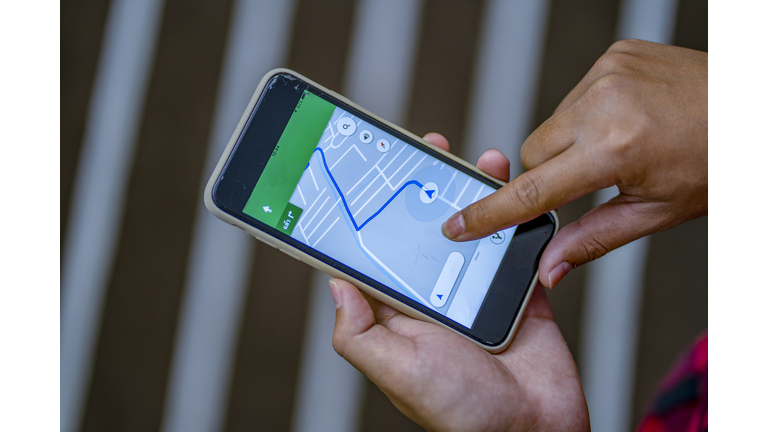 Close up of man using  Smartphone with a GPS map