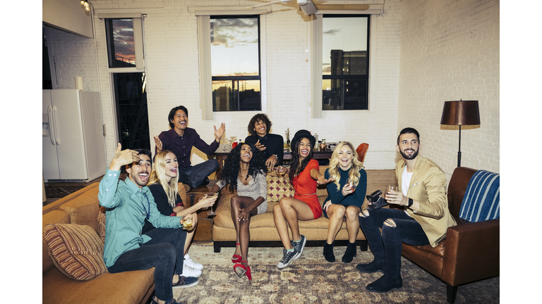 Group of friends celebrating while watching television