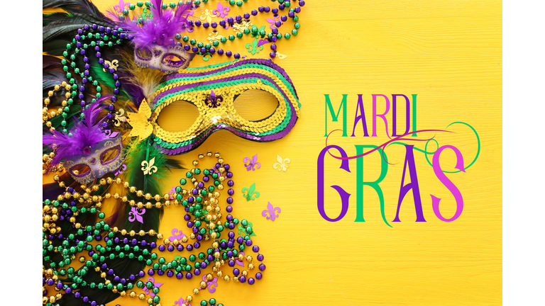 Holidays image of mardi gras masquarade venetian mask over yellow background. view from above