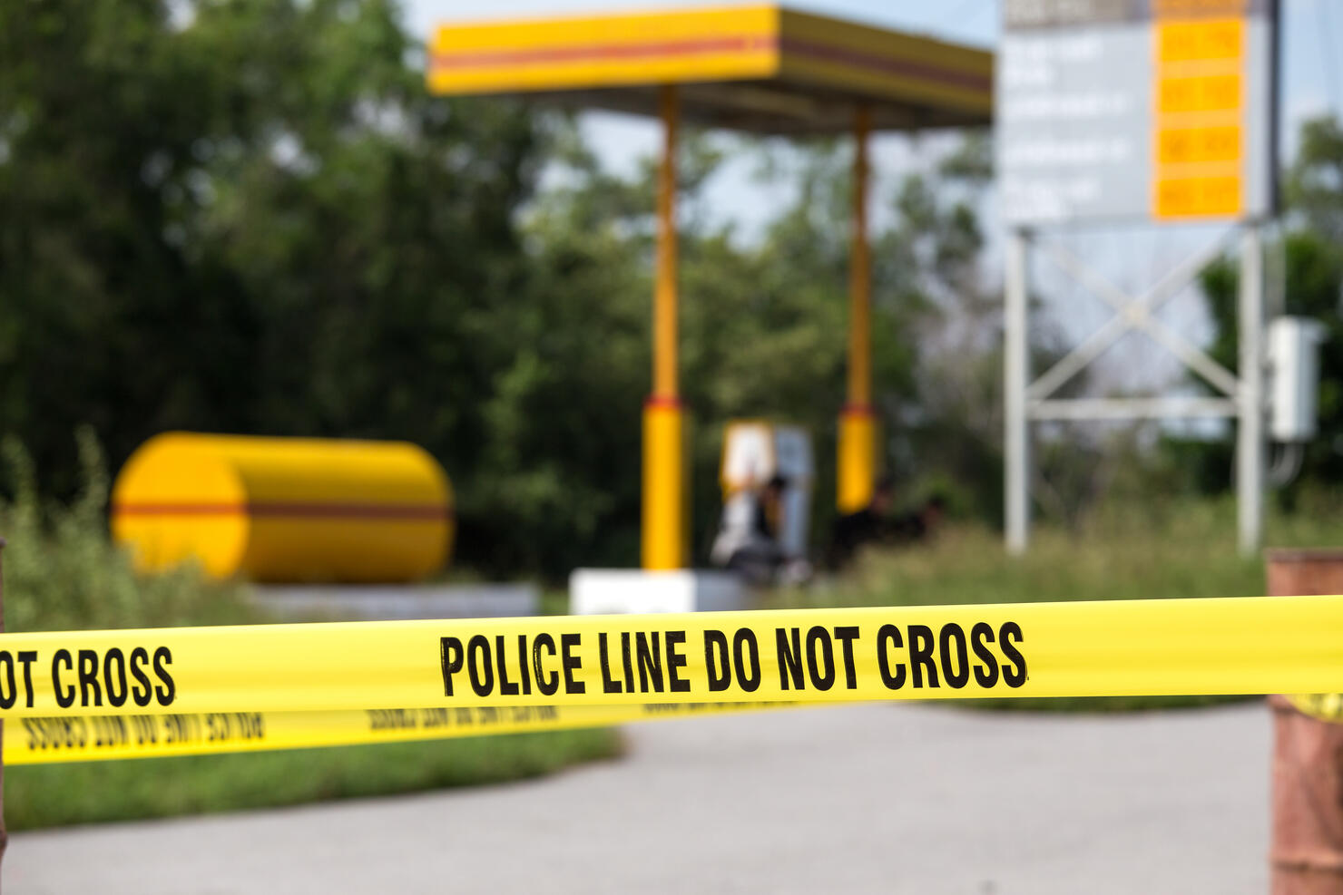 police line do no cross with gas station background