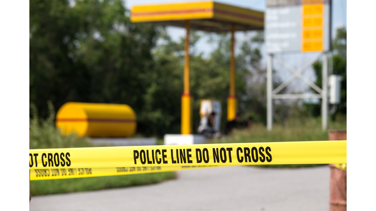 police line do no cross with gas station background