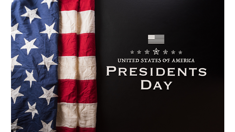 Happy presidents day concept with flag of the United States and the text on dark  background.