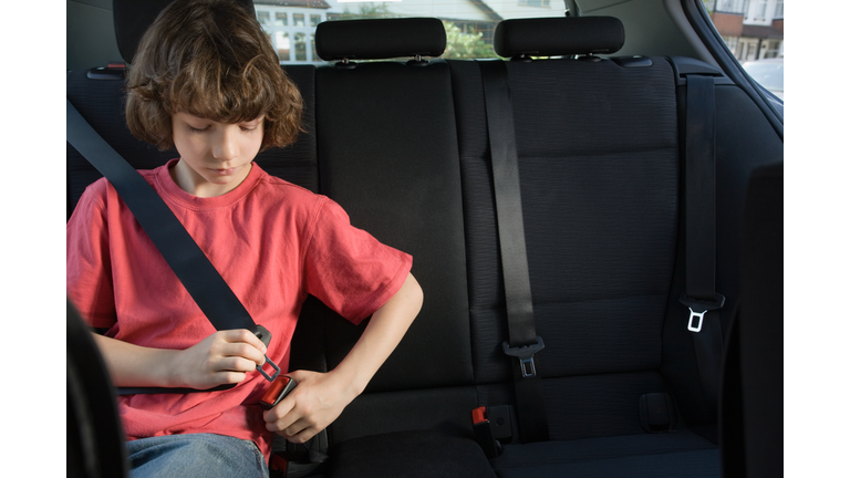 Boy fastening his seatbelt