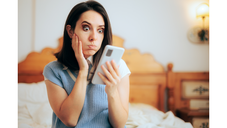 Funny Woman in Shock Reading Text Message on her Phone