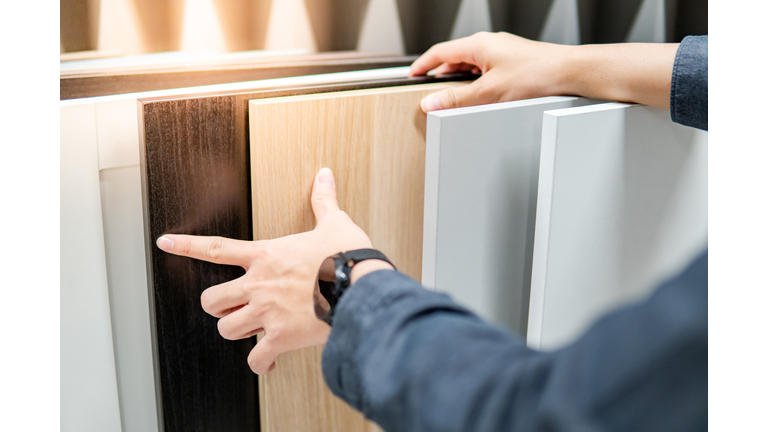 Male hand choosing cabinet or countertop materials