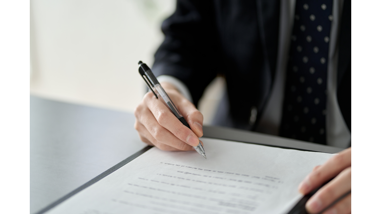 Asian businessman signing a contract