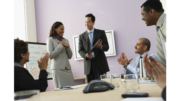 Businesswoman receiving plaque