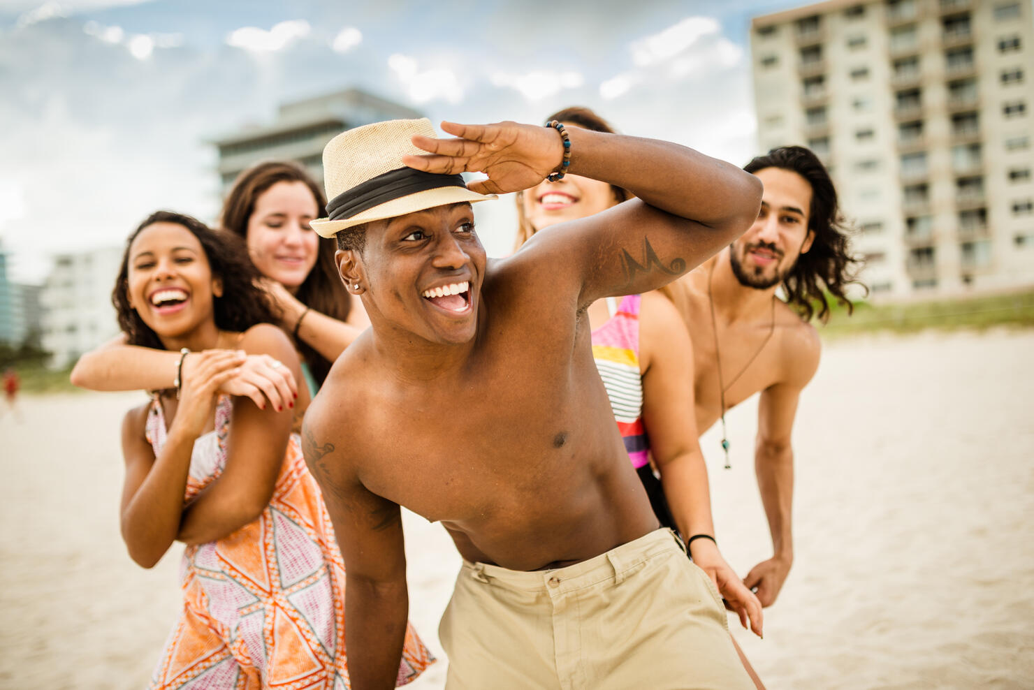 friends dancing on the beach for a party
