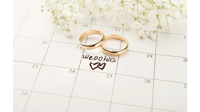 Word wedding on calendar with sweet flowers