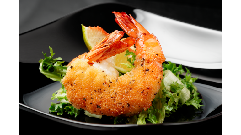 Deep fried shrimps on black plate