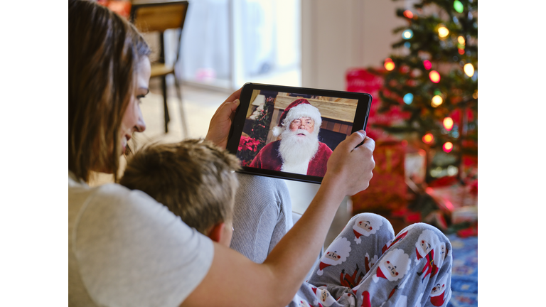 Father and Daughter Talking to Santa Claus on a Video Call