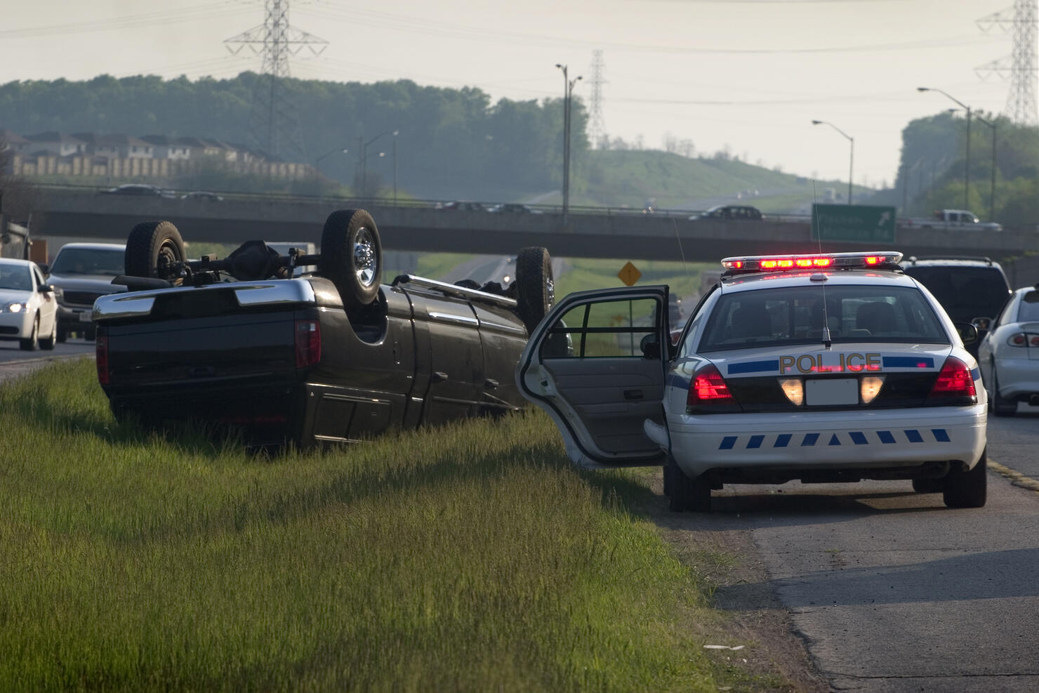 Police car parked by truck accident crash