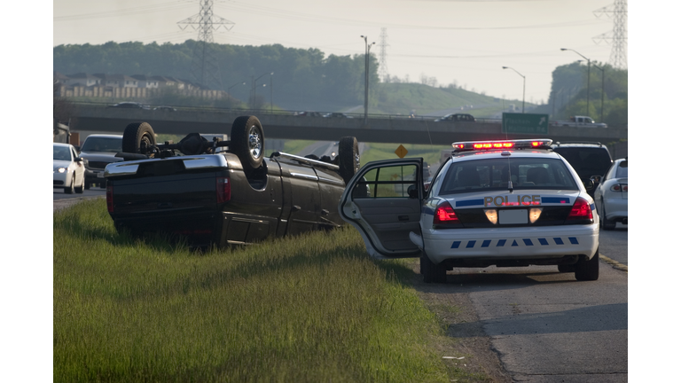 Police car parked by truck accident crash
