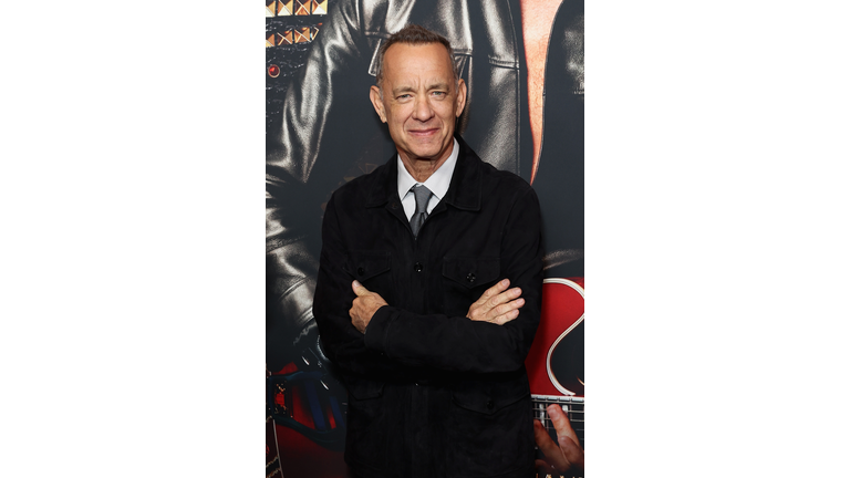 Tom Hanks in a black suit.