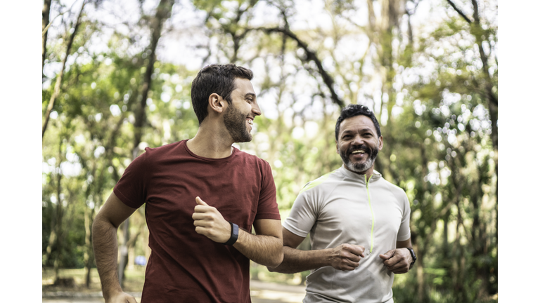 Friends running together in a park