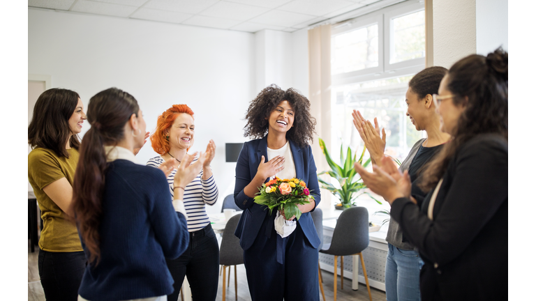 Businesswomen celebrating an achievement of a colleague