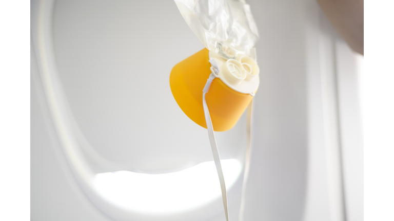 oxygen mask drop from the ceiling compartment on airplane