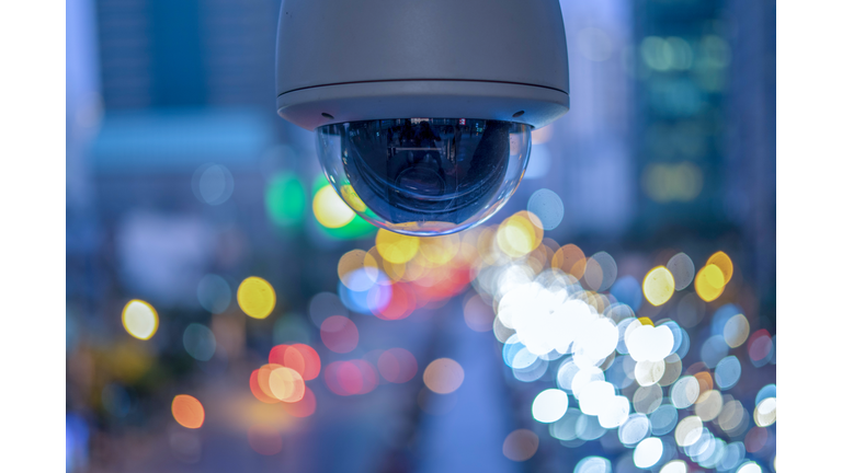 CCTV overhead for security on the road or in town and with soft car and building background.