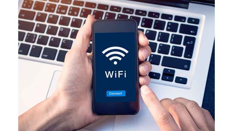 Connect to WiFi wireless internet network with smartphone at coffee shop or hotel with button on mobile device screen, free public hotspot secure access to web for email and website browsing