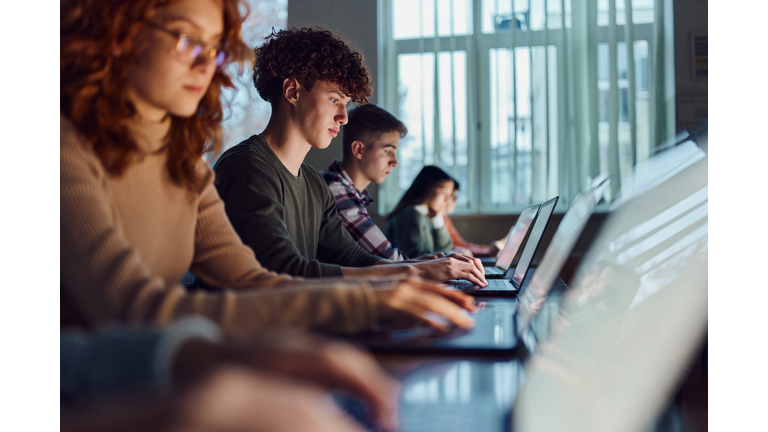 High school students e-learning over computers in the classroom.