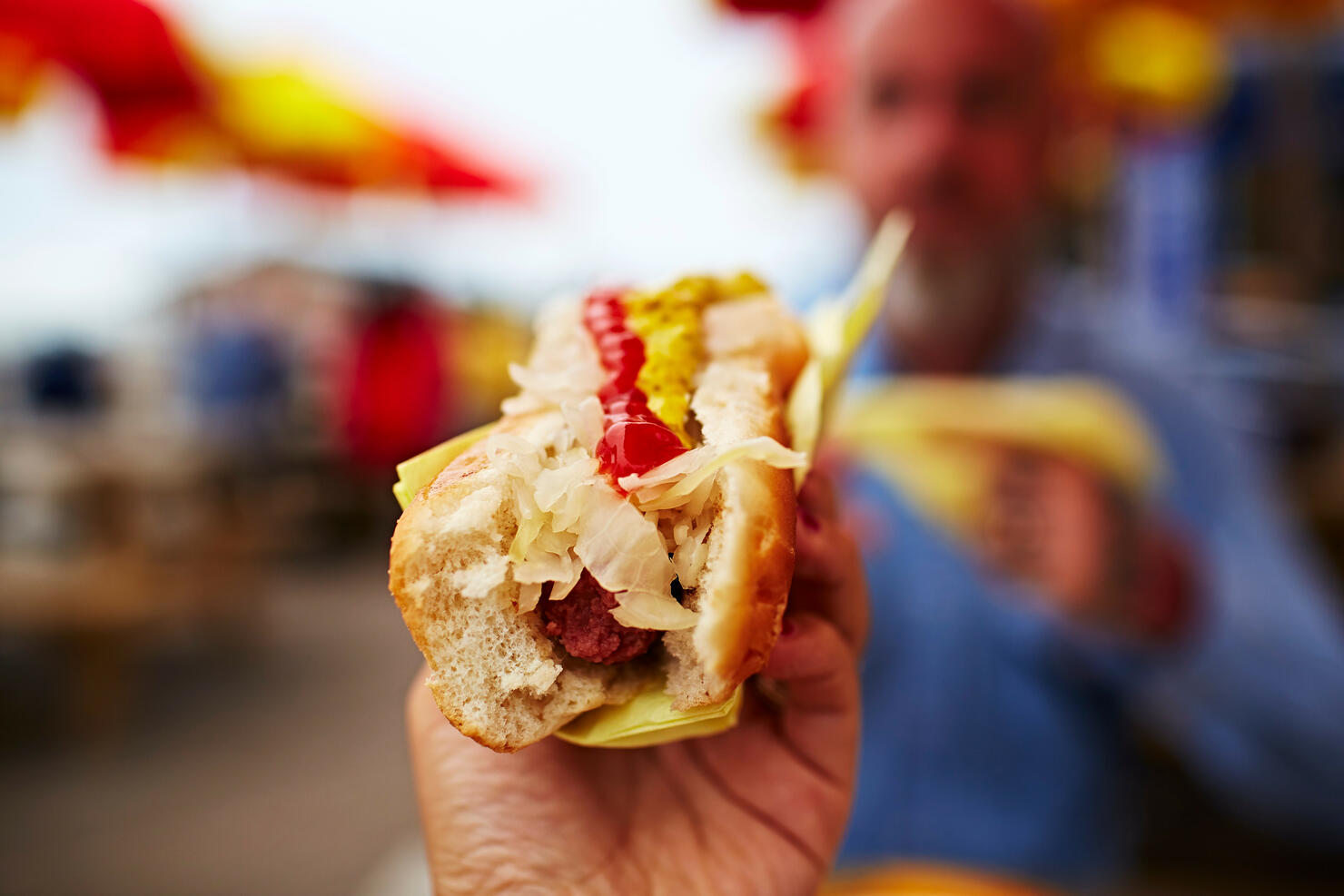 Hand holding hotdog
