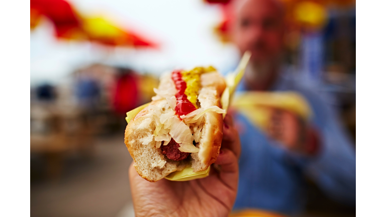 Hand holding hotdog