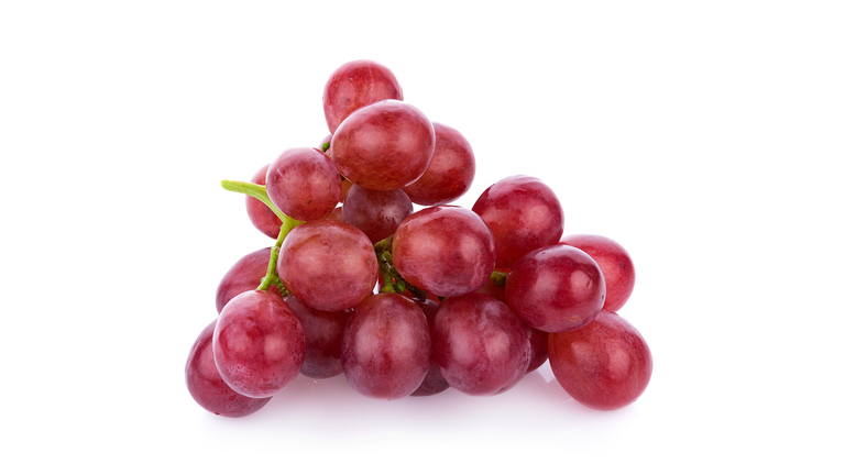 Close-Up Of Red Grapes Against White Background