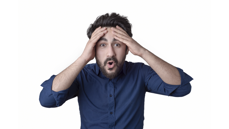 Portrait of young man with shocked facial expression