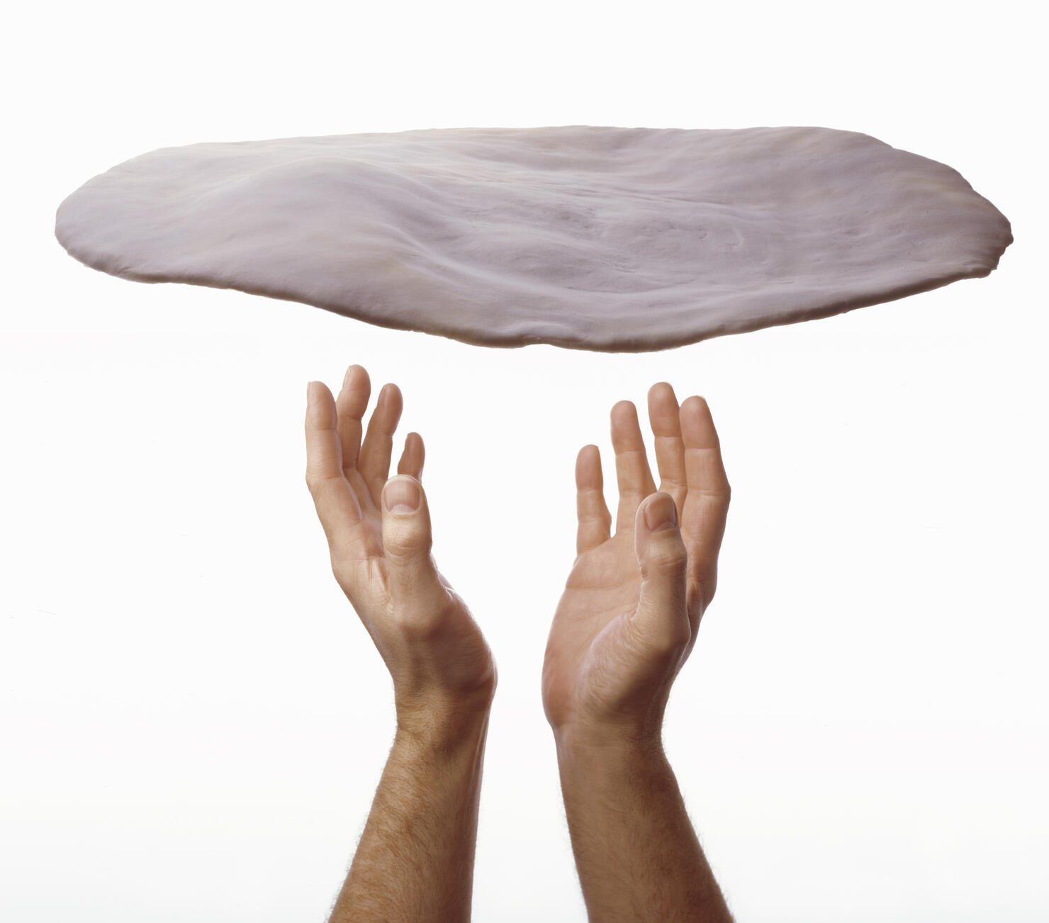 man throwing pizza dough