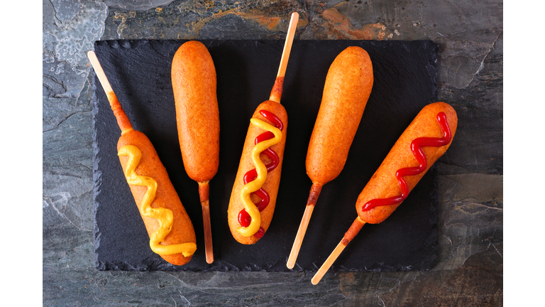 Corn dogs on a slate platter