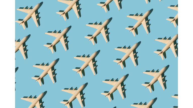 Seamless pattern with toy airplane on blue background. Creative travel concept