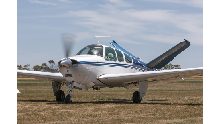 Beech V35 Bonanza single engine light aircraft taxiing at Lethbridge airfield.