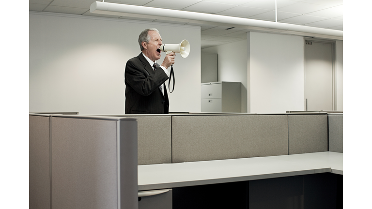 Businessman shouting through megaphone